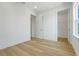 Bright bedroom with light wood floors, view to the en suite and a walk-in closet at 3496 Amberjack Dr, Hernando Beach, FL 34607