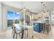 Bright dining area with a glass table, modern chairs, and an open view of the stylish kitchen and backyard at 3496 Amberjack Dr, Hernando Beach, FL 34607