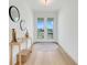 Bright entryway with white walls, wood floors, and stylish decor leading to double doors with neighborhood view at 3496 Amberjack Dr, Hernando Beach, FL 34607