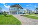 Charming two-story home with a two-car garage, a balcony, and a brick-paved driveway at 3496 Amberjack Dr, Hernando Beach, FL 34607