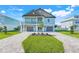 Beautiful two-story home with a two-car garage, balcony, and well-manicured lawn at 3496 Amberjack Dr, Hernando Beach, FL 34607