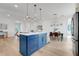 Open-concept kitchen featuring a large blue island, stainless steel appliances, and views of the living room at 3496 Amberjack Dr, Hernando Beach, FL 34607