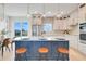 Modern kitchen with quartz countertops, a blue island, stainless steel appliances, and a patterned backsplash at 3496 Amberjack Dr, Hernando Beach, FL 34607