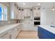 Gourmet kitchen featuring white cabinets, designer backsplash, stainless steel appliances, and a center island at 3496 Amberjack Dr, Hernando Beach, FL 34607