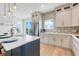 Modern kitchen with white cabinets, quartz countertops, a blue island, and stainless steel appliances at 3496 Amberjack Dr, Hernando Beach, FL 34607