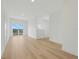 An airy living room features light wood floors and a sliding glass door at 3496 Amberjack Dr, Hernando Beach, FL 34607
