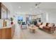 Open concept living room featuring modern furniture, ample natural light, and seamless connection to the kitchen at 3496 Amberjack Dr, Hernando Beach, FL 34607