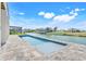 Modern pool with serene water views, set in a stylish patio area by the canal at 3496 Amberjack Dr, Hernando Beach, FL 34607