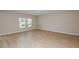 Bedroom featuring laminated floors, neutral walls, and natural light at 37214 Sagemoor Dr, Zephyrhills, FL 33541