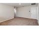 Large, neutral-toned bedroom with carpet flooring and a glimpse into connecting rooms at 37214 Sagemoor Dr, Zephyrhills, FL 33541
