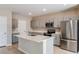Bright kitchen featuring a center island, stainless steel appliances, and gray cabinets at 37214 Sagemoor Dr, Zephyrhills, FL 33541