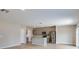 Open-concept living area with kitchen, featuring laminated floors, and stainless steel appliances at 37214 Sagemoor Dr, Zephyrhills, FL 33541