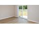 Bright room featuring laminated floors, neutral walls, and glass door to the patio at 37214 Sagemoor Dr, Zephyrhills, FL 33541