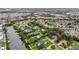 Aerial view of a waterfront home nestled among mature trees, with a private boat dock at 424 Island Cay Way, Apollo Beach, FL 33572