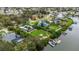 Aerial view of the property with boat dock and lush backyard near the water and a lake for enjoying the outdoor lifestyle at 424 Island Cay Way, Apollo Beach, FL 33572