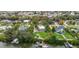 Waterfront home with a boat dock and backyard pool, surrounded by lush landscaping and mature trees at 424 Island Cay Way, Apollo Beach, FL 33572
