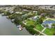 Waterfront property featuring a boat dock and lush tropical landscaping around the backyard pool at 424 Island Cay Way, Apollo Beach, FL 33572