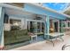 Covered back porch featuring a comfortable sofa, ceiling fan, and access to indoor/outdoor living spaces at 424 Island Cay Way, Apollo Beach, FL 33572