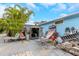 View of cluttered backyard with a small shed and various items strewn about the area at 424 Island Cay Way, Apollo Beach, FL 33572