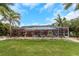 Backyard features lush greenery and mature landscaping, complemented by vibrant plants, creating a tranquil outdoor setting at 424 Island Cay Way, Apollo Beach, FL 33572
