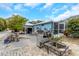 Spacious backyard with a stone patio, grill, fire pit, and various seating areas for outdoor entertaining at 424 Island Cay Way, Apollo Beach, FL 33572
