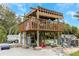 Backyard with a raised wooden platform featuring an American flag, outdoor furniture, and ample space at 424 Island Cay Way, Apollo Beach, FL 33572