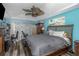Spacious bedroom featuring a dark-wood bed frame, ceiling fan and a large window with curtains at 424 Island Cay Way, Apollo Beach, FL 33572