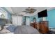 View of the bedroom with a ceiling fan, wooden closet doors, and neutral toned walls at 424 Island Cay Way, Apollo Beach, FL 33572