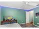 View of the bedroom with light green walls and a vintage, grey-painted dresser at 424 Island Cay Way, Apollo Beach, FL 33572