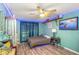 Well-lit bedroom features a ceiling fan, wood-look floors and unique LED strip lighting at 424 Island Cay Way, Apollo Beach, FL 33572