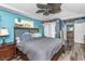 Bright bedroom featuring wood-look floors, a large window, and wood furnishings at 424 Island Cay Way, Apollo Beach, FL 33572