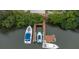 Birds eye view of private dock on canal with three boats and stairs to waterfront property at 424 Island Cay Way, Apollo Beach, FL 33572