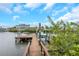 Waterfront property with a private wooden dock and boat, perfect for boating and enjoying scenic water views at 424 Island Cay Way, Apollo Beach, FL 33572