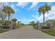 Gated community entrance with lush landscaping, stone signage, and paved road, providing privacy and curb appeal at 424 Island Cay Way, Apollo Beach, FL 33572