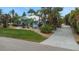 Well-maintained home with a lush lawn, tropical landscaping, and a paved driveway, perfect for relaxing at 424 Island Cay Way, Apollo Beach, FL 33572
