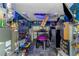Organized garage featuring cabinets, shelving, and a three-wheeled ATV at 424 Island Cay Way, Apollo Beach, FL 33572