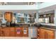 Charming kitchen features wood cabinetry, granite countertops, and stainless steel appliances at 424 Island Cay Way, Apollo Beach, FL 33572