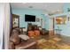 Cozy living room with a leather sectional, stylish stone floors, and contemporary decor at 424 Island Cay Way, Apollo Beach, FL 33572