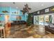 Open living area with tile floors, decorative ceiling fans, and access to the outdoor pool area at 424 Island Cay Way, Apollo Beach, FL 33572