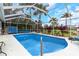 Screened pool with tropical landscaping and spacious deck, perfect for outdoor relaxation and entertaining at 424 Island Cay Way, Apollo Beach, FL 33572