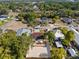Aerial view of residential neighborhood featuring tree coverage, houses, and streetscape at 439 E Boyer St, Tarpon Springs, FL 34689