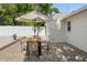Backyard patio featuring dining furniture, paved bricks, and fenced yard at 439 E Boyer St, Tarpon Springs, FL 34689