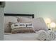 Close-up of a bedroom with soft pillows, decorative items, and cozy textiles for a peaceful ambiance at 439 E Boyer St, Tarpon Springs, FL 34689