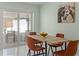 Bright dining room featuring a table with four chairs, next to a sliding door leading to outdoor patio at 439 E Boyer St, Tarpon Springs, FL 34689