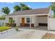 Inviting single-story home with a covered carport, manicured lawn, and brick accents at 439 E Boyer St, Tarpon Springs, FL 34689