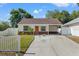 Charming single-story home featuring a cozy front porch and well-maintained landscaping at 439 E Boyer St, Tarpon Springs, FL 34689