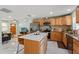 Open-concept kitchen with stainless steel appliances, granite counters, and an island with seating at 439 E Boyer St, Tarpon Springs, FL 34689