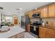 Modern kitchen with stainless steel appliances, wood cabinets, and a convenient island at 439 E Boyer St, Tarpon Springs, FL 34689