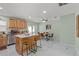 Modern kitchen with stainless steel appliances, a breakfast bar, and an adjacent dining area at 439 E Boyer St, Tarpon Springs, FL 34689