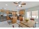 Well-lit kitchen with stainless steel appliances, wood cabinets, and a view to the outdoor patio at 439 E Boyer St, Tarpon Springs, FL 34689